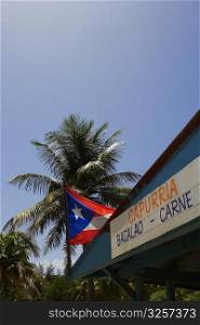 Low angle view of a Puerto Rican flag shade on the roof of a restaurant, Pinones Beach, Puerto Rico