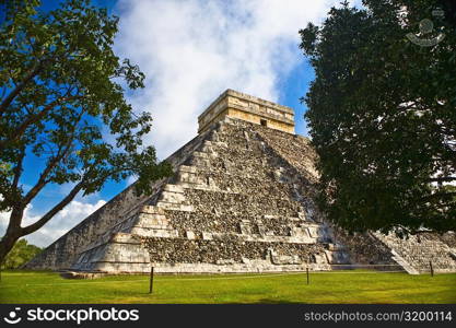 Low angle view of a pyramid on a landscape, Chichen Itza, Yucatan, Mexico