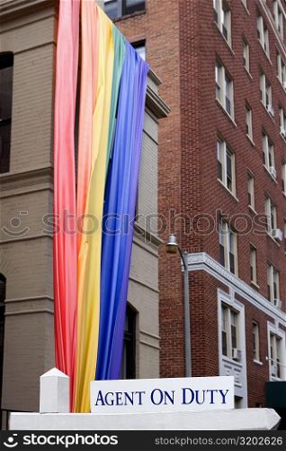 Low angle view of a rainbow flag hanging on a building
