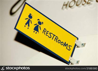 Low angle view of a Restroom sign on a wall