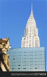 Low angle view of a sculpture in font of a skyscraper, Empire State Building, New York City, New York State, USA