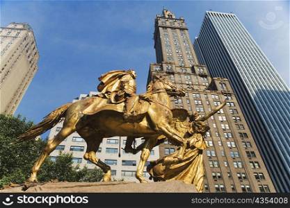 Low angle view of a sculpture with skyscrapers, New York City, New York State, USA