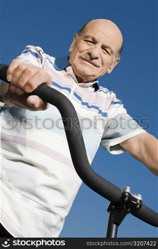 Low angle view of a senior man on a bicycle