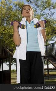Low angle view of a senior woman exercising with dumbbells