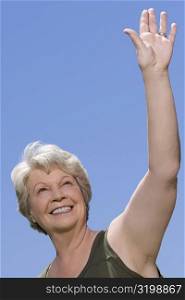 Low angle view of a senior woman waving her hand
