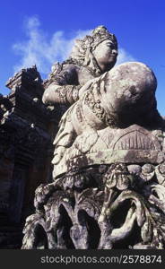 Low angle view of a statue in front of a temple, Bali, Indonesia