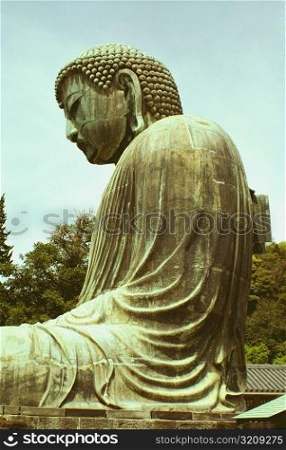Low angle view of a statue of Buddha, Great Buddha, Kamakura, Kanagawa Prefecture, Japan