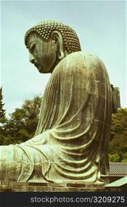 Low angle view of a statue of Buddha, Great Buddha, Kamakura, Kanagawa Prefecture, Japan
