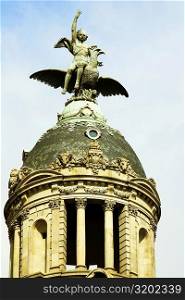 Low angle view of a statue on a dome, Barcelona, Spain