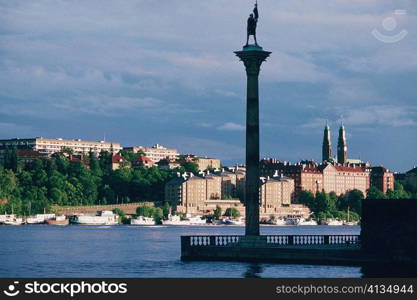 Low angle view of a statue on a pillar in a harbor, Stockholm, Sweden