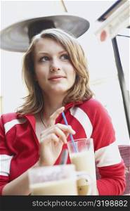 Low angle view of a teenage girl sitting in a restaurant