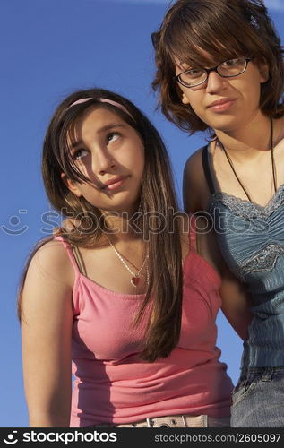 Low angle view of a teenage girl standing with her sister