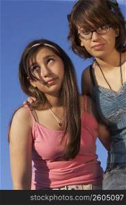 Low angle view of a teenage girl standing with her sister