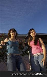 Low angle view of a teenage girl standing with her sister