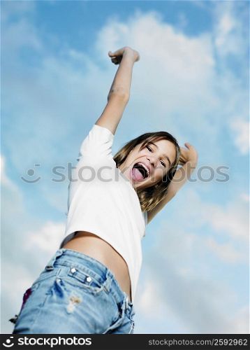 Low angle view of a teenage girl with her arms raised