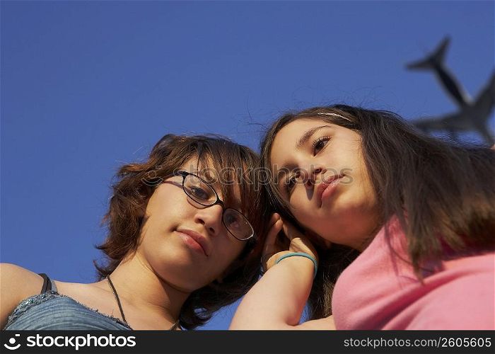 Low angle view of a teenage girl with her sister