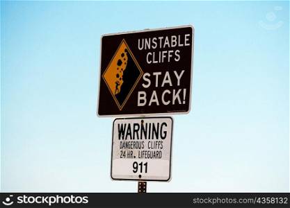 Low angle view of a warning sign, San Diego, California, USA