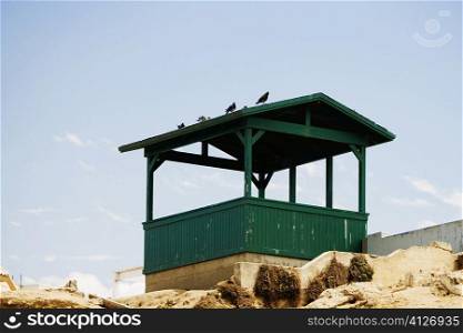 Low angle view of a wooden gazebo on the beach