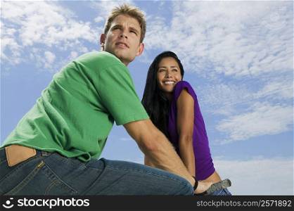 Low angle view of a young couple looking away