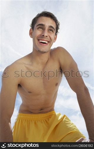 Low angle view of a young man smiling