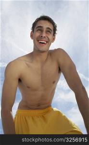 Low angle view of a young man smiling