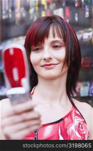 Low angle view of a young woman holding a mobile phone