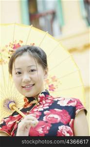 Low angle view of a young woman holding a parasol