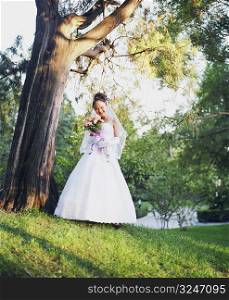 Low angle view of a young woman in the wedding dress