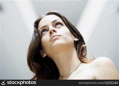 Low angle view of a young woman looking serious