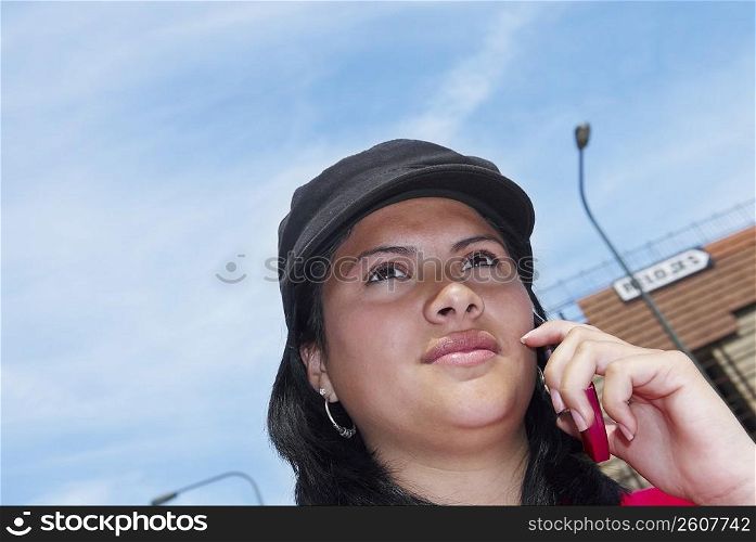 Low angle view of a young woman talking on a mobile phone