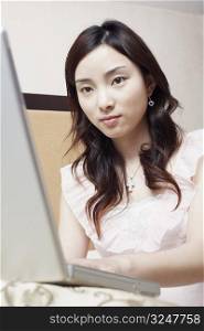 Low angle view of a young woman using a laptop