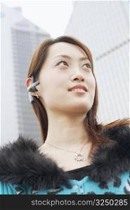 Low angle view of a young woman wearing a hands free device