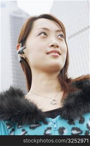 Low angle view of a young woman wearing a hands free device