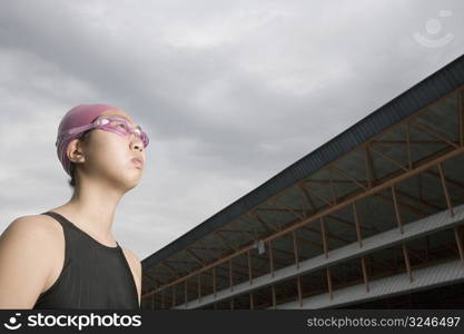 Low angle view of a young woman wearing swimming goggles