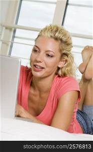 Low angle view of a young woman working on a laptop