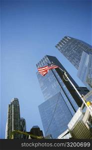 Low angle view of an American flag in front of buildings, Columbus Circle, Manhattan, New York City, New York State, USA