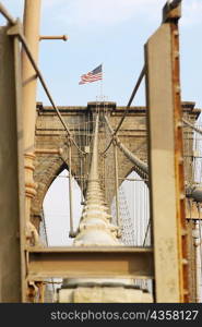 Low angle view of an American flag on a bridge, Brooklyn Bridge, New York City, New York State, USA