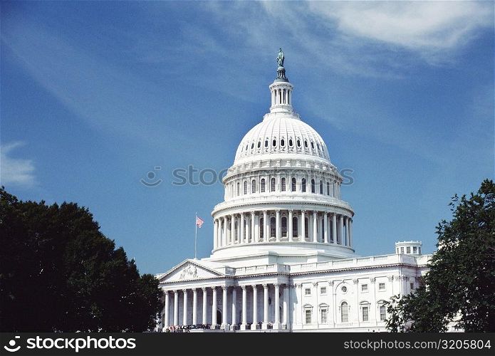Low angle view of an American flag on a government building, Capitol Building, Washington DC, USA