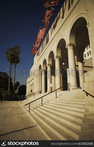 Low angle view of an arrangement of American flags outside a building, City Hall, Los Angeles, California, USA