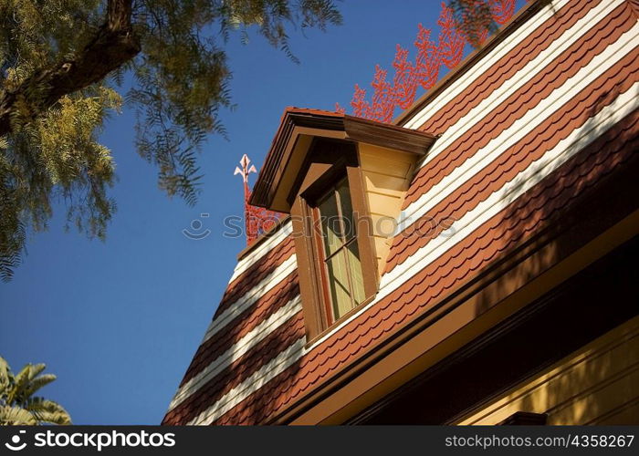 Low angle view of an attic window on a rooftop, San Diego, California, USA