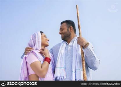 Low angle view of an Indian couple smiling