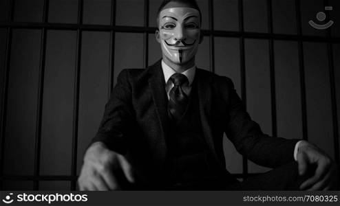 Low angle view of Anonymous hacker in prison (B/W Version)