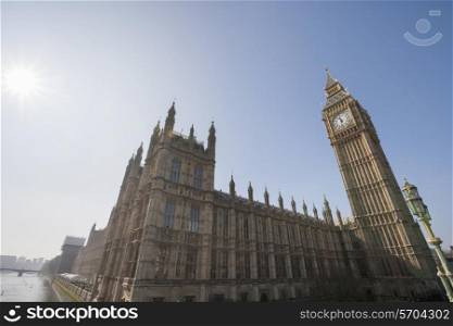 Low angle view of Big Ben and parliament building against clear sky at London; England; UK