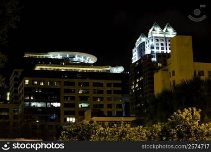 Low angle view of buildings lit up at night, Orlando, Florida, USA
