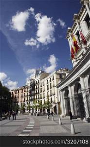 Low angle view of buildings on the roadside, Madrid, Spain