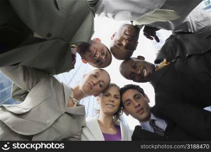 Low angle view of business executives standing in a huddle