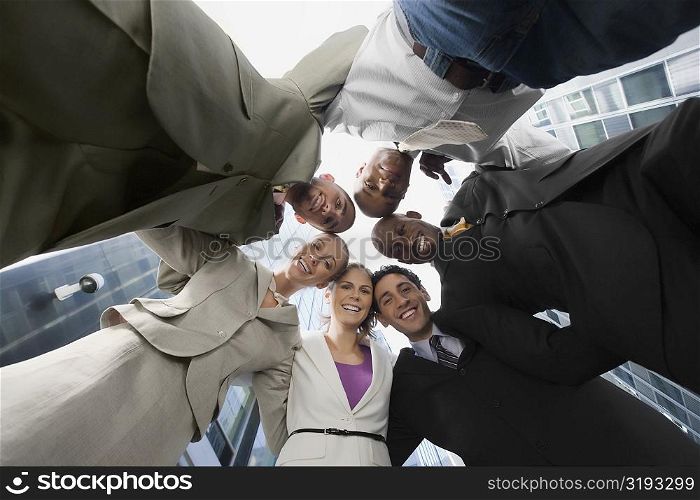 Low angle view of business executives standing in a huddle