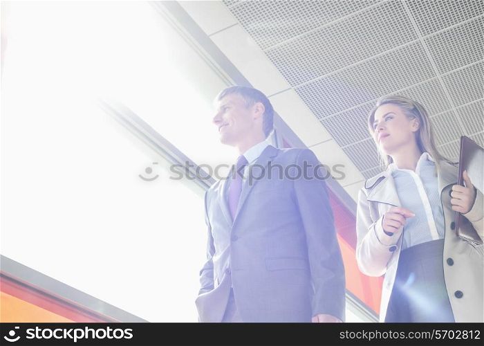 Low angle view of business people walking in railroad station
