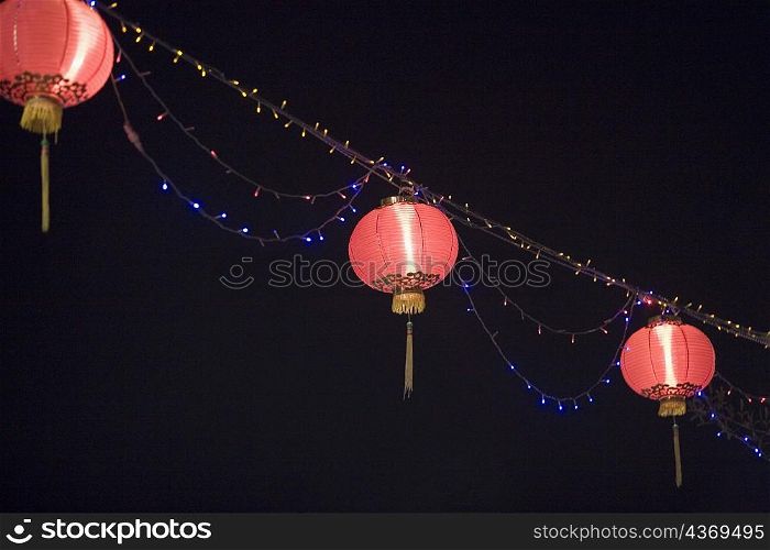 Low angle view of Chinese lanterns lit up at night