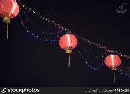 Low angle view of Chinese lanterns lit up at night